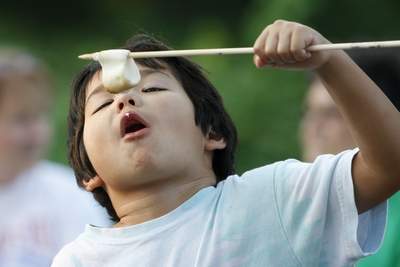 Kid eating a marshmallow